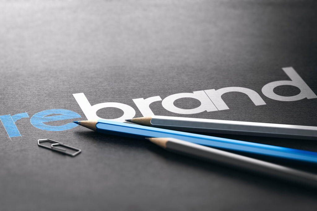 Word,Rebrand,With,The,Prefix,Re,Handwritten,Over,Black,Paper