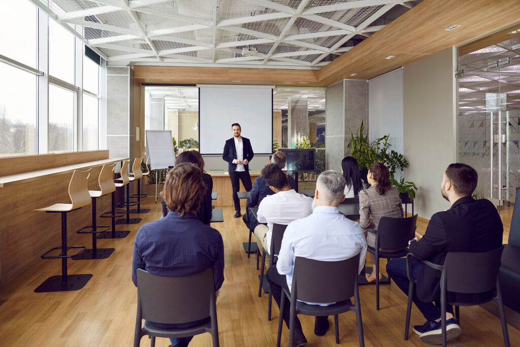 Professional,Business,Coach,Standing,By,A,White,Board,In,Front